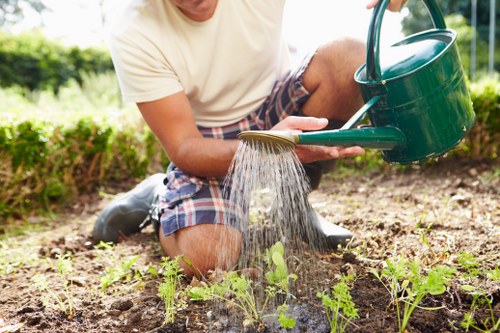 Worker inspecting landscaping tools and machinery before use on site